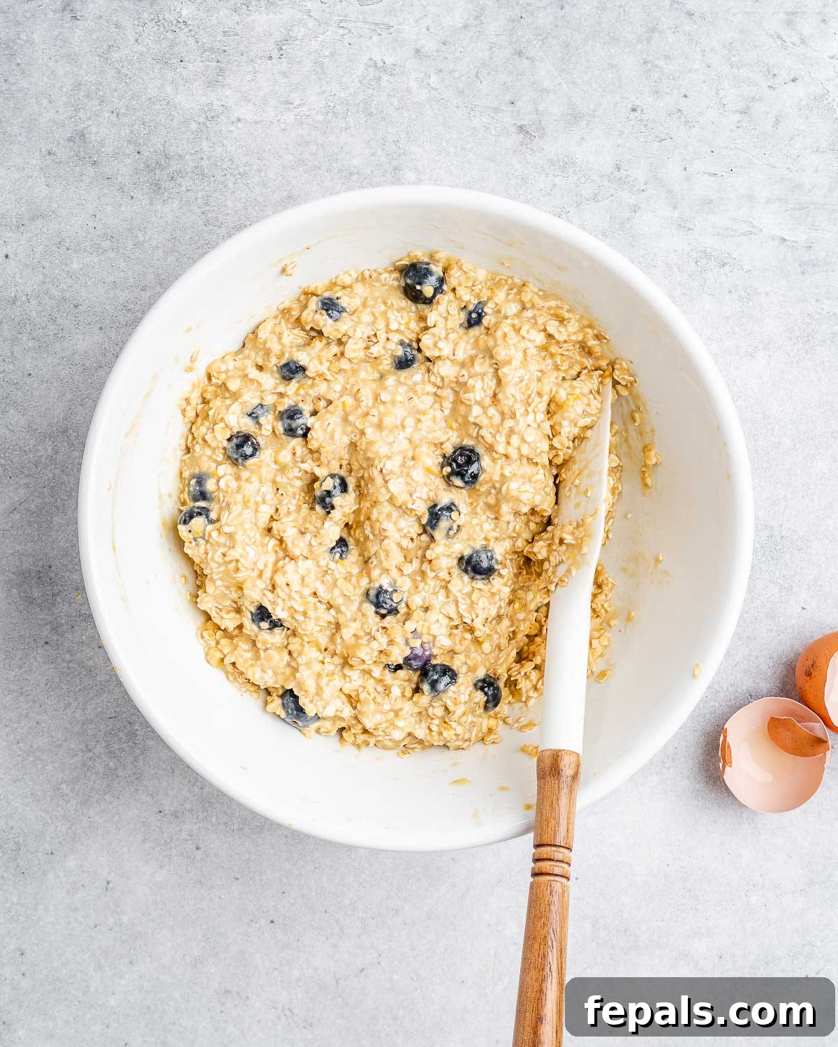 Soft-Baked Blueberry Oatmeal Cookies 7 A bowl filled with finished oatmeal blueberry cookie dough, ready to be scooped onto a baking sheet.