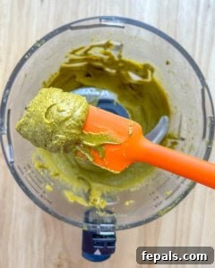 Spatula with pistachio butter on it, demonstrating the creamy consistency.