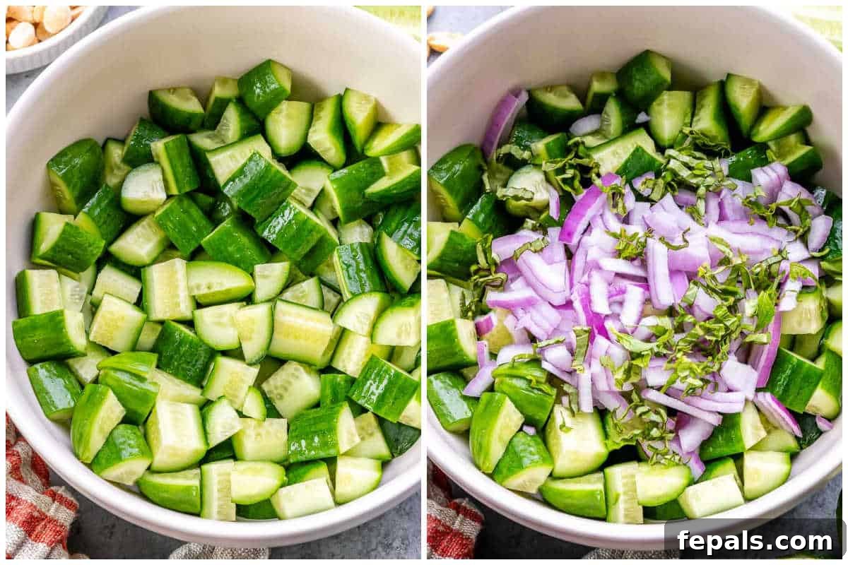 Process shot showing chopped cucumbers, thinly sliced red onion, and fresh Thai basil in a mixing bowl.