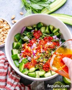 pouring dressing over cucumbers