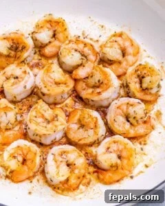 Close-up of shrimp coated in seasoning, ready to be cooked.