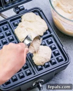 batter being poured onto the waffle maker.