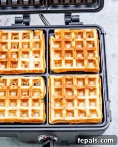 cooked waffles on the waffle maker.