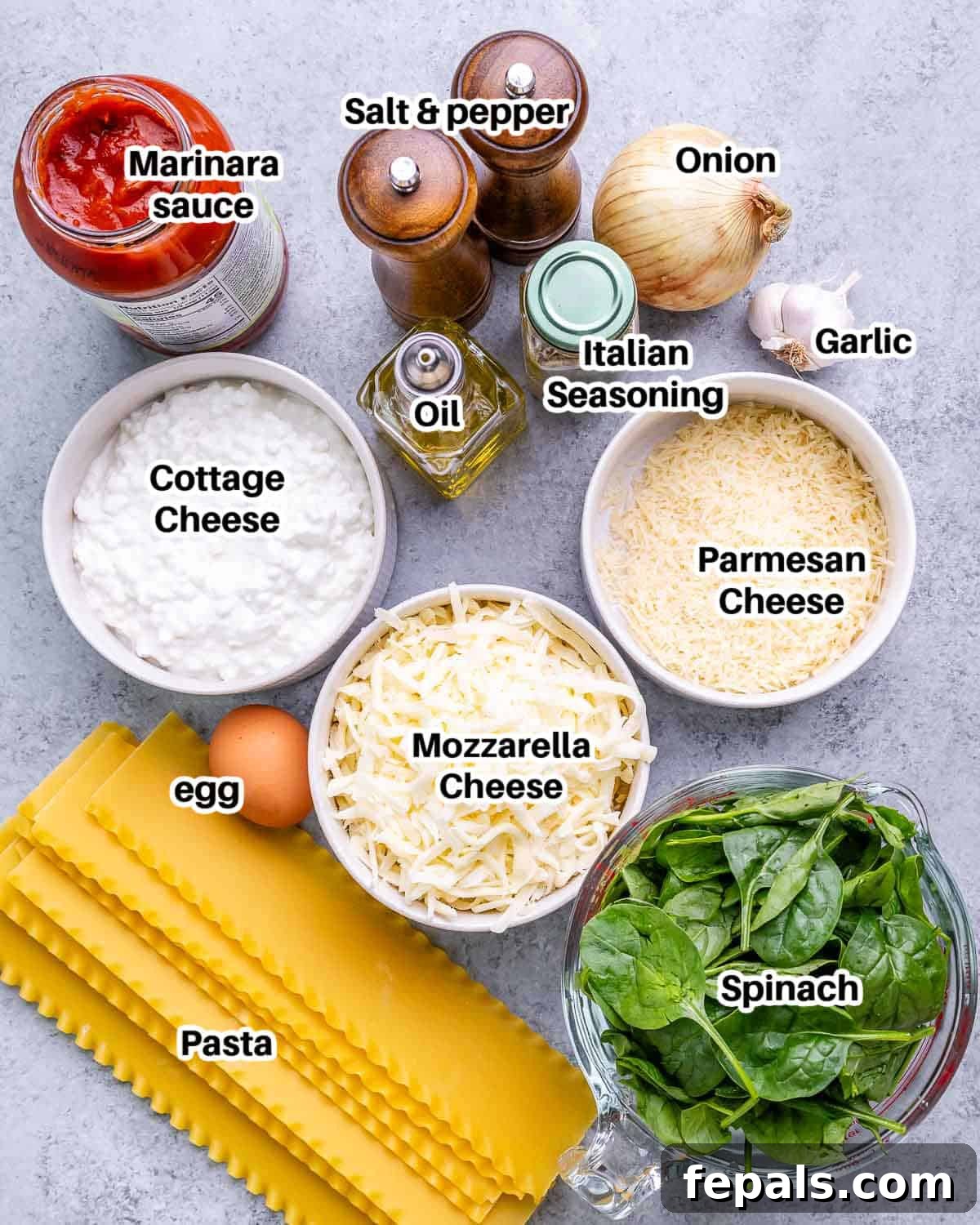 Homestyle Cottage Cheese Lasagna 3 A flat lay photograph showcasing all the fresh ingredients required to prepare a wholesome Cottage Cheese Lasagna, including noodles, various cheeses, spinach, and aromatics.