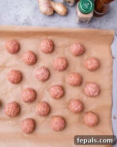 Sticky Teriyaki Turkey Meatballs 10 Raw meat balls on a baking tray.