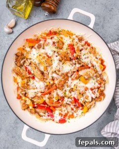 Full view of the finished Chicken Philly Cheesesteak skillet, loaded with melted cheese, chicken, and colorful vegetables.