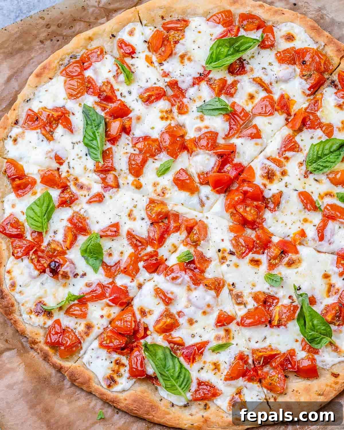 Garden-Fresh Bruschetta Pizza 2 A vibrant Bruschetta Pizza, freshly baked, topped with diced tomatoes, melted mozzarella, and fresh basil leaves. The whole pizza is shown from an overhead perspective, highlighting its golden crust and inviting colors.