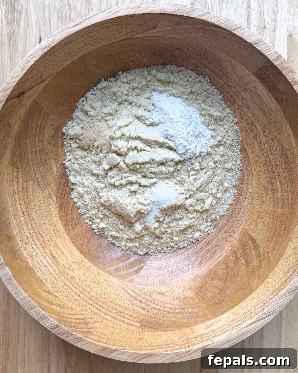 Low-Carb Almond Bagels 4 A bowl containing dry ingredients for almond flour bagels: almond flour, onion powder, and baking powder.