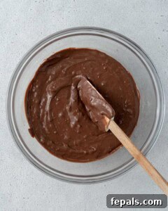 Bowl of chocolate batter with a spatula in it.