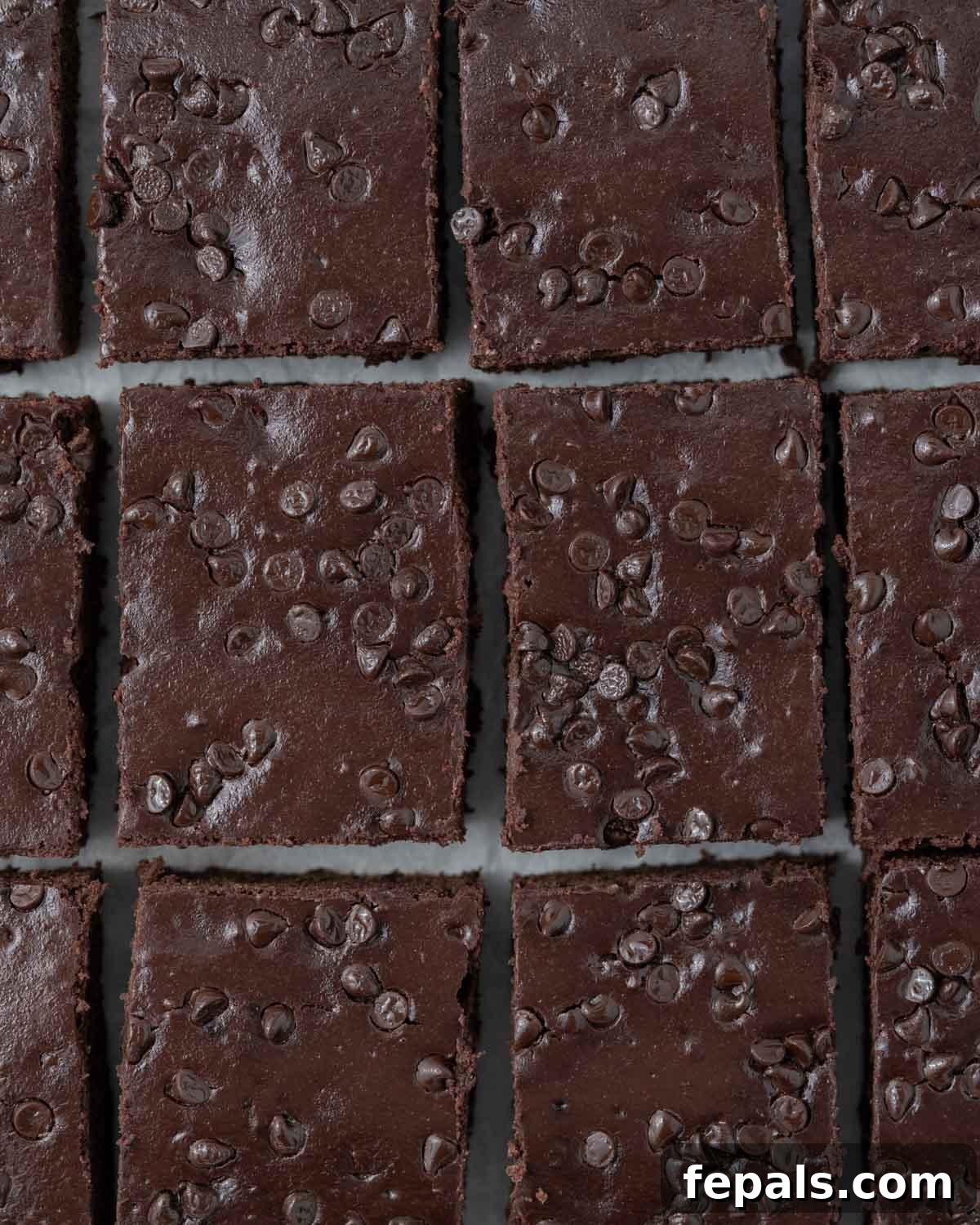 Secret Ingredient Greek Yogurt Brownies 3 A close-up of a single brownie slice being held to show its soft, cake-like texture.
