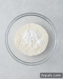 Bowl of dry ingredients including flour, baking powder, baking soda, and salt.