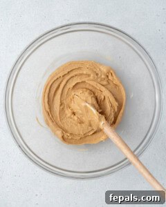 Peanut butter and honey are mixed in a bowl.