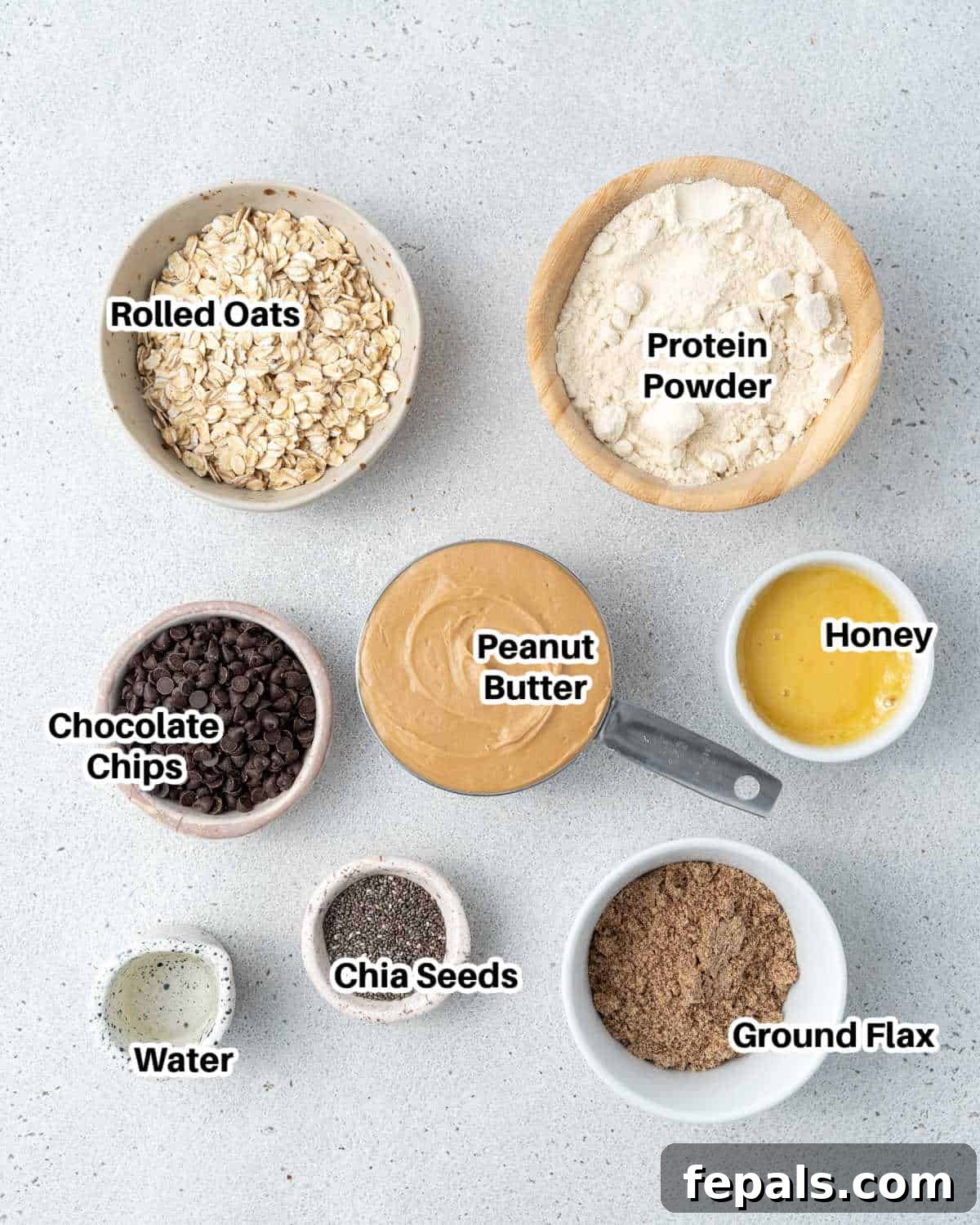 Various ingredients for protein energy bites laid out on a clean surface.