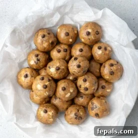 Peanut butter protein balls on parchment paper on a plate.