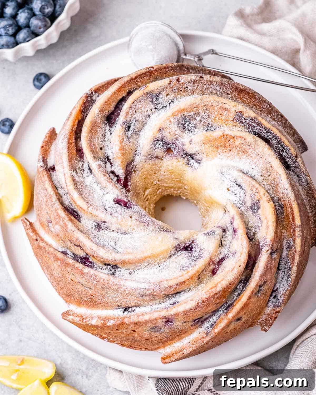 Lemon Blueberry Bliss Bundt 2 lemon bundt cake dusted with powdered sugar