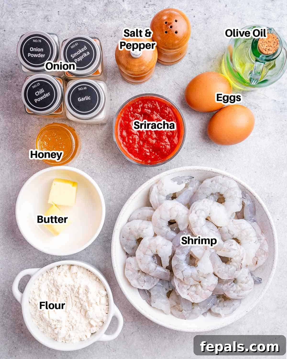 A flat lay photograph displaying all the fresh ingredients required to make delicious buffalo shrimp.