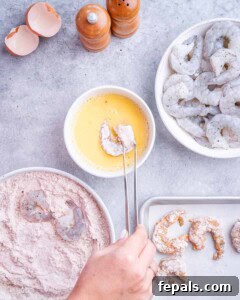 Raw shrimp coated in flour and egg, ready for frying.