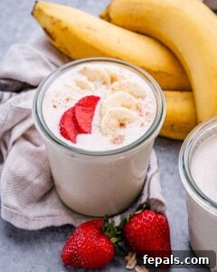 Smooth Overnight Oats 10 A jar with blended oats topped with sliced strawberries and bananas.