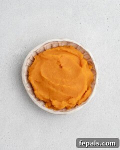 A bowl of freshly cooked and mashed sweet potato, ready for the cookie dough.