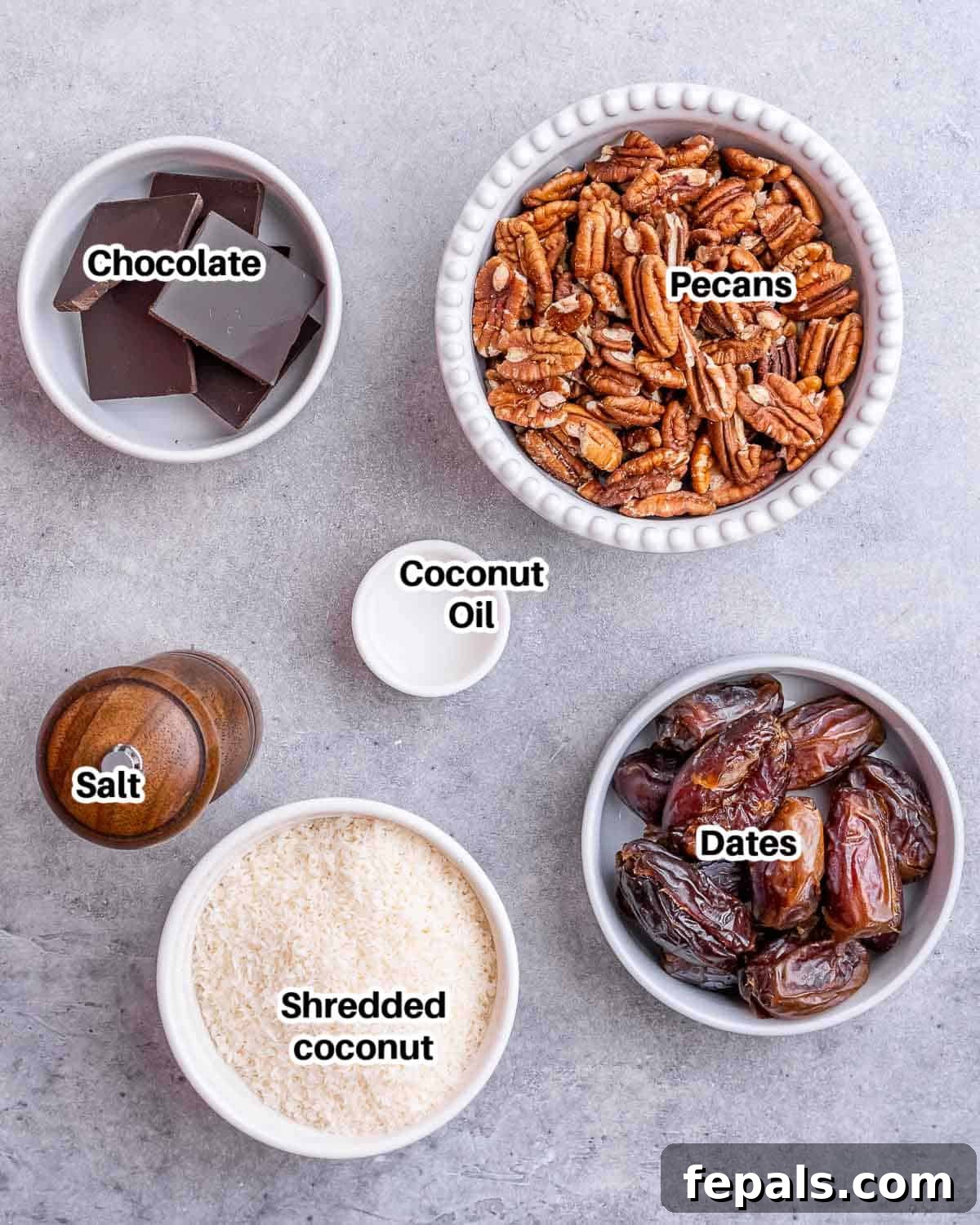Various ingredients laid out for making Samoa cookies, including dates, pecans, coconut, and chocolate.