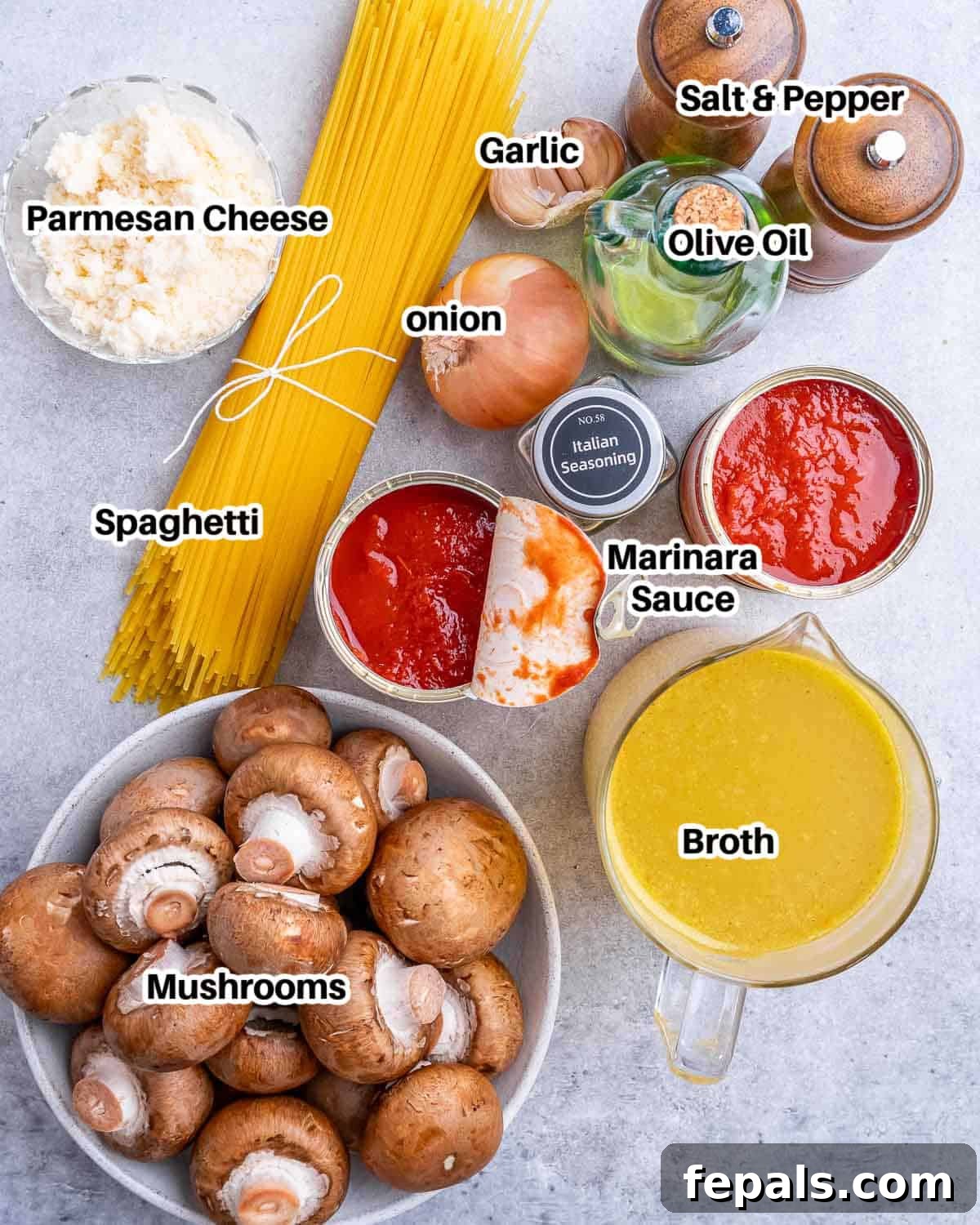 Effortless Instant Pot Spaghetti 3 Assorted fresh ingredients laid out to make spaghetti in an Instant Pot, including mushrooms, onion, garlic, marinara sauce, and spaghetti noodles.