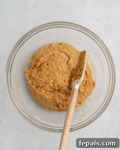 Sweet potato batter bread mixture in a bowl before adding mix-ins.