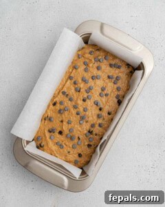 Sweet potato bread batter placed in a loaf pan, ready for baking.