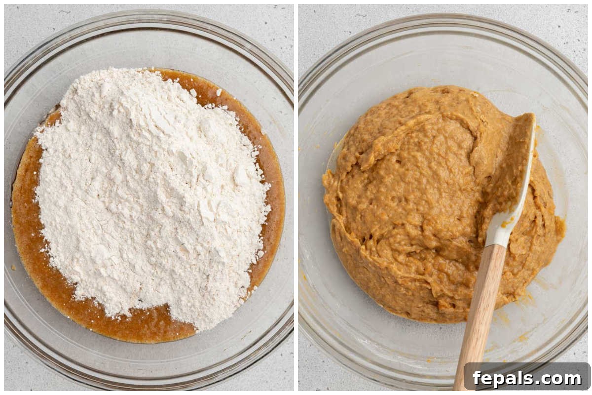 A process shot showing the combined wet and dry ingredients being gently mixed in a large bowl, forming the sweet potato bread batter.