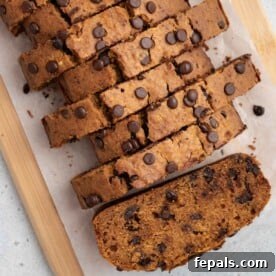 Sliced sweet potato bread on parchment paper, showcasing its moist interior and chocolate chips.
