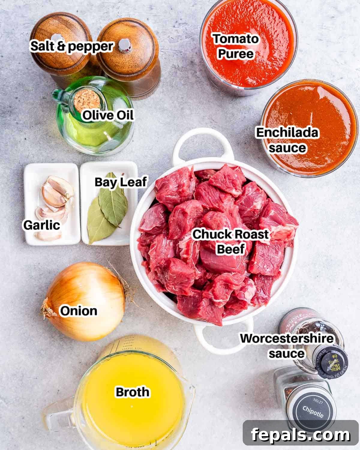 Ingredients to make Texas chili, laid out on a wooden board.