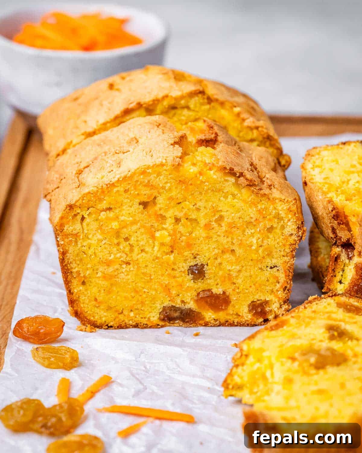 Close-up of sliced carrot cake loaf sliced, showing its golden color and moist interior.