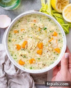 Avgolemono Soup: A Bowl of Bright Comfort 13 A pot of finished Avgolemono Soup with bright carrots, rice, and parsley, ready to be served