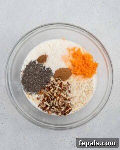 Adding dry ingredients like oats, carrots, pecans, chia seeds, coconut, cinnamon, and nutmeg to the liquid mixture.