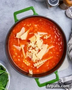 Adding noodles and spinach to the soup