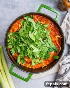 Mixing ricotta and spinach into the soup