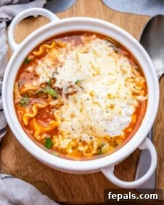 Served vegetarian lasagna soup topped with cheese and herbs