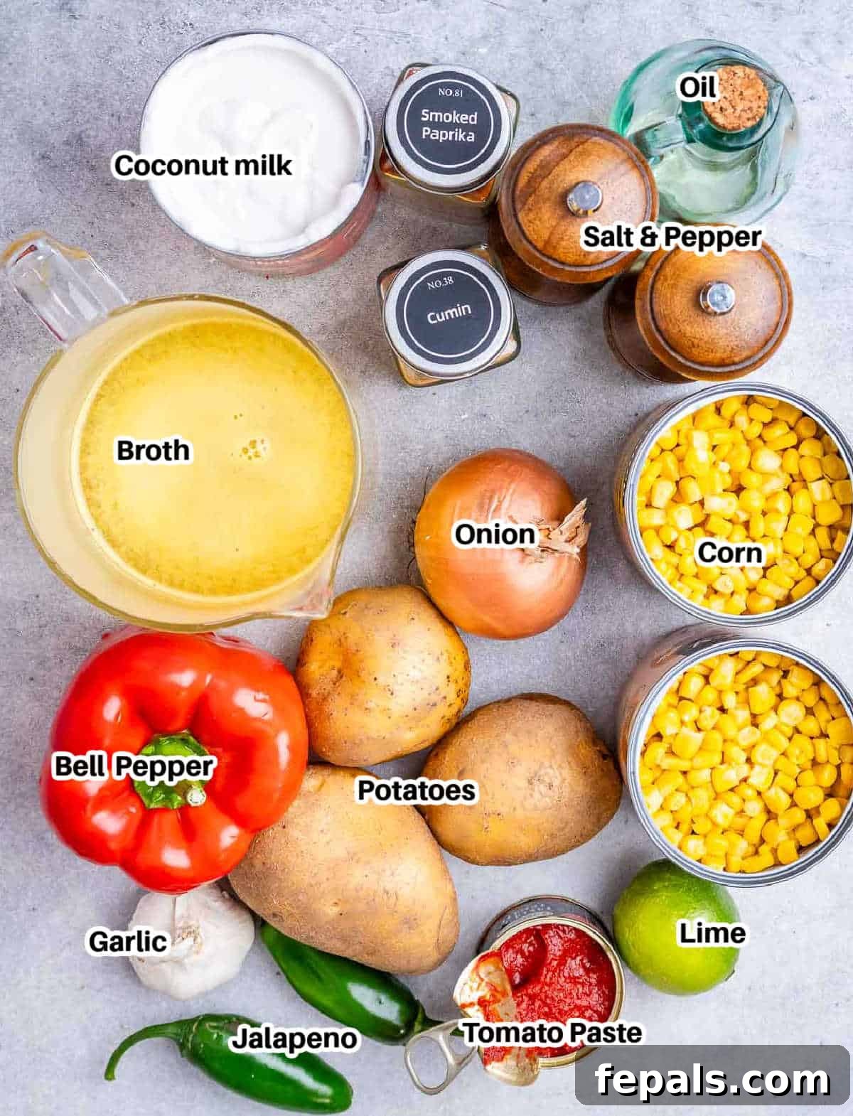 A vibrant flat lay image showcasing all the fresh and canned ingredients required to prepare a delicious Mexican street corn soup. You can see corn cans, fresh jalapenos, bell peppers, onions, garlic, potatoes, a lime, and various spices.