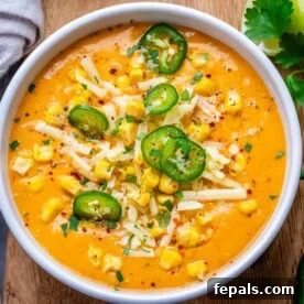 A bowl of creamy Mexican Street Corn Soup, garnished with vibrant green cilantro and yellow corn kernels, ready to be enjoyed.