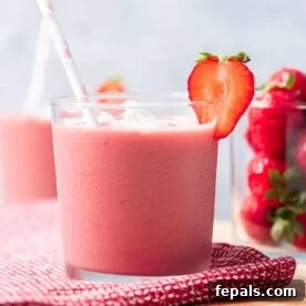 A refreshing strawberry banana smoothie, beautifully presented in a tall glass, showcasing its creamy texture and vibrant color, ready to be enjoyed.