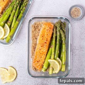 Grilled salmon over quinoa with a side of grilled asparagus topped over quinoa.