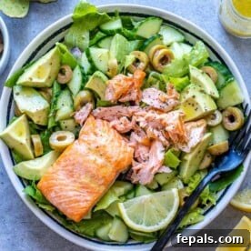 Salmon topped over salad bowl