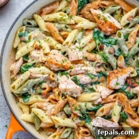 Top view salmon pasta in an orange skillet
