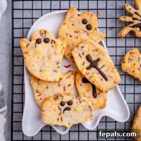 Halloween ghost and spider cookies on a plate.