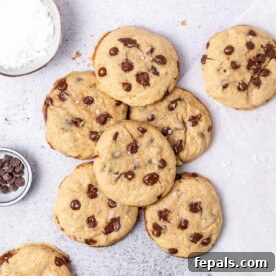 Several chocolate chip cookies on a flat surface.