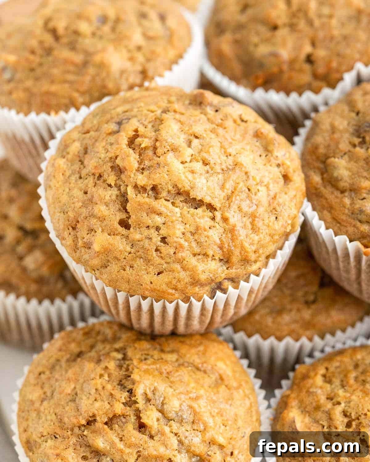Stacked carrot and banana muffins, showcasing their fluffy texture.