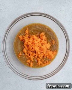 grated carrots added over the egg and banana mixture.