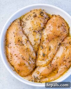 Seasoned chicken breast in a bowl.