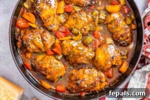 Finished chicken stew with veggies in a skillet.
