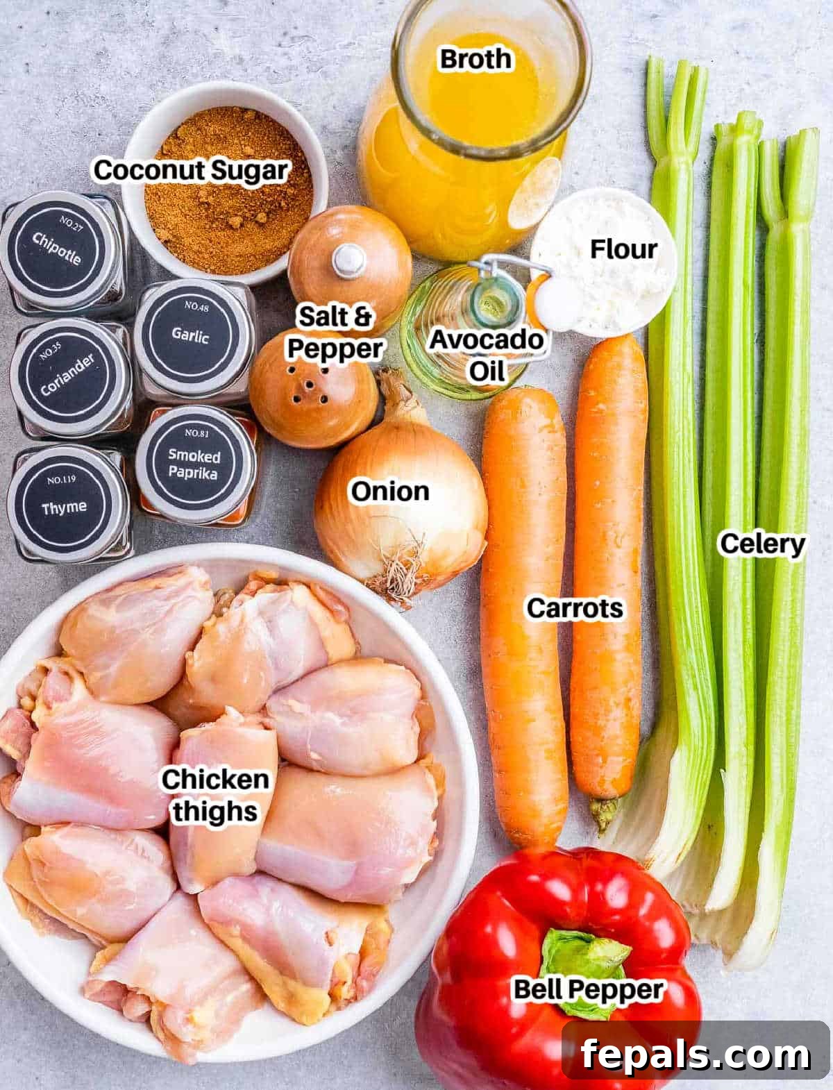 Classic Caribbean Brown Stew Chicken 3 A collection of fresh ingredients laid out for making brown chicken stew, including various vegetables, chicken, and spices.