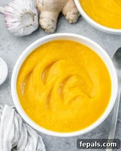 Blending the soup with an immersion blender until smooth and creamy.